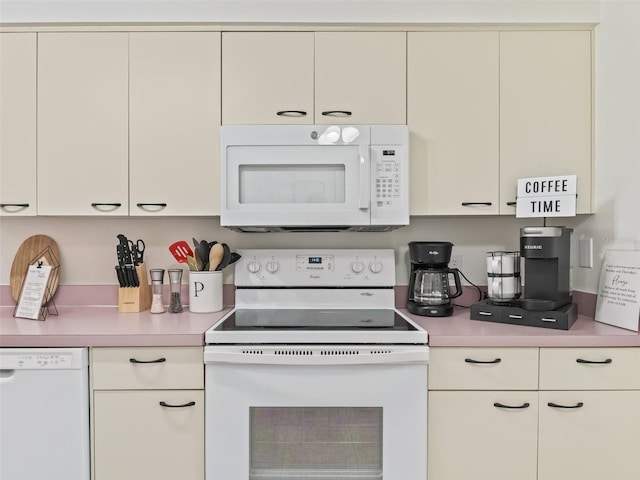 1405 W Schwartz Blvd, The Villages, FL 32159 - kitchen with white appliances, light countertops, and white cabinetry