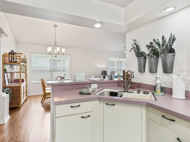 1405 W Schwartz Blvd, The Villages, FL 32159 - kitchen with a chandelier, light countertops, light wood-style flooring, and hanging light fixtures