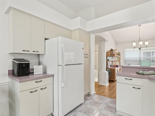 1405 W Schwartz Blvd, The Villages, FL 32159 - kitchen featuring decorative columns, freestanding refrigerator, decorative light fixtures, a chandelier, and vaulted ceiling