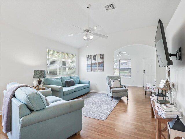 1405 W Schwartz Blvd, The Villages, FL 32159 - living area featuring a ceiling fan, vaulted ceiling, light wood-style floors, and arched walkways