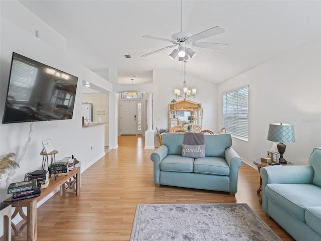 1405 W Schwartz Blvd, The Villages, FL 32159 - living room with ceiling fan, light wood-style floors, a chandelier, and vaulted ceiling