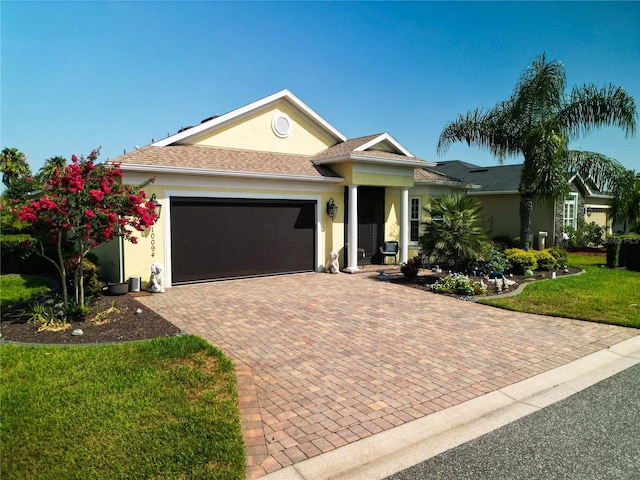 view of front of house with a garage and a front lawn