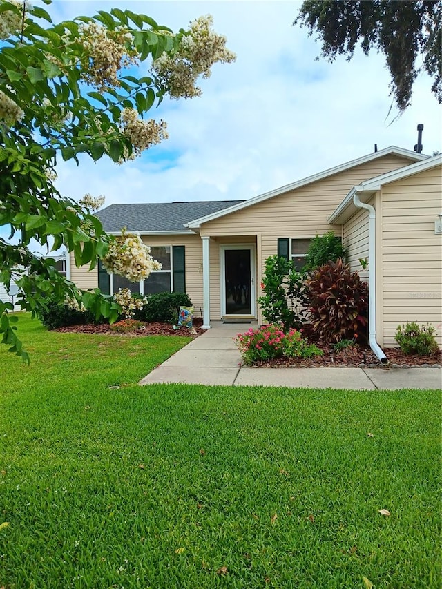 ranch-style home featuring a front yard