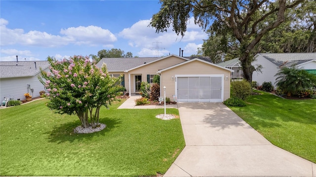 ranch-style house featuring a garage, concrete driveway, and a front yard