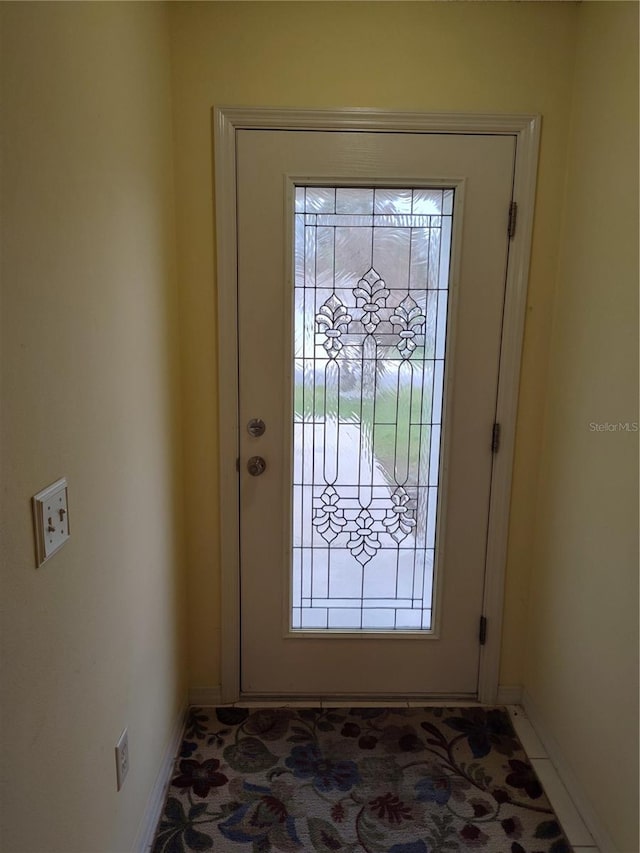 doorway to outside with tile patterned floors