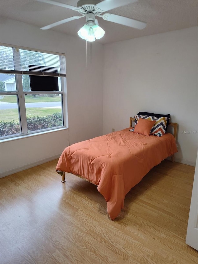 bedroom featuring light wood-type flooring and ceiling fan