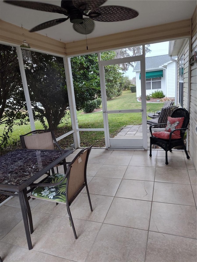 sunroom / solarium featuring ceiling fan