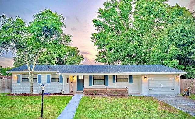 single story home with brick siding, concrete driveway, covered porch, a front yard, and a garage