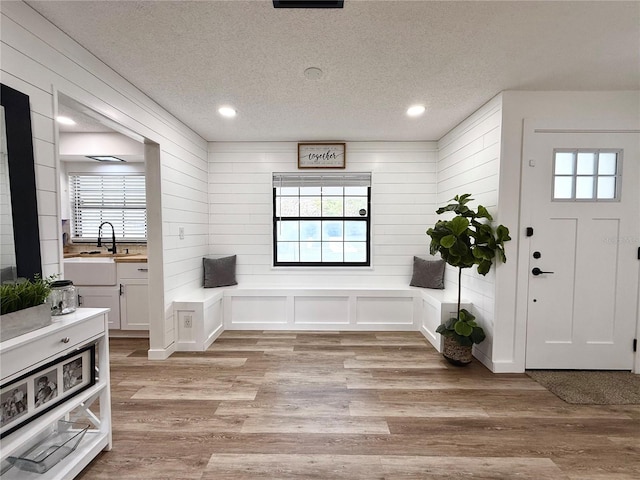entrance foyer featuring a textured ceiling, light wood-style flooring, and recessed lighting