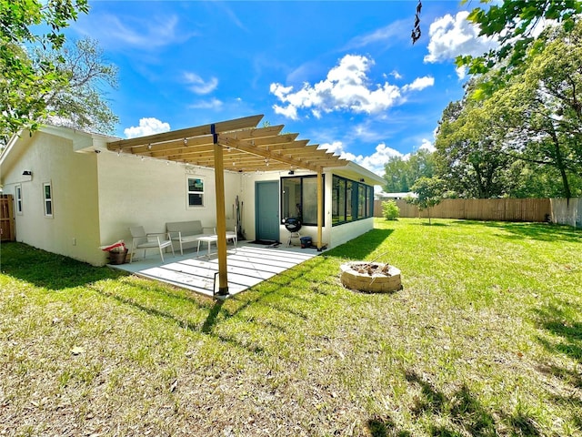 back of house featuring an outdoor fire pit, a patio, a sunroom, fence private yard, and a pergola