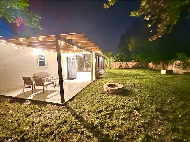view of yard featuring a fire pit, a patio area, a fenced backyard, and a pergola