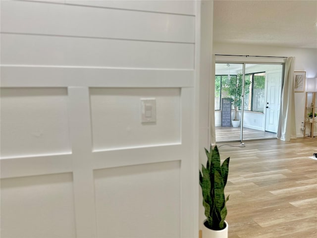 interior space featuring a textured ceiling and wood finished floors
