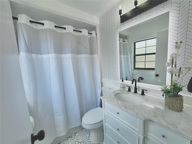 full bath featuring toilet, a shower with shower curtain, and vanity