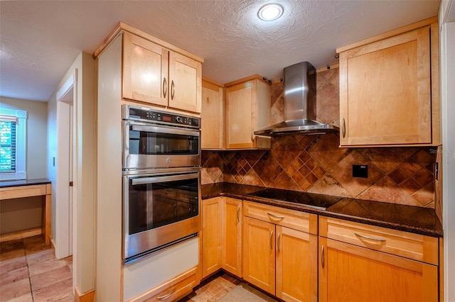 601 W Old Highway 441 Unit 11B, Mount Dora, FL 32757 - kitchen with wall chimney exhaust hood, black electric cooktop, stainless steel double oven, tasteful backsplash, and dark stone counters