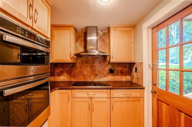 601 W Old Highway 441 Unit 11B, Mount Dora, FL 32757 - kitchen featuring wall chimney exhaust hood, stainless steel double oven, healthy amount of natural light, dark countertops, and a textured ceiling