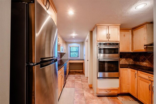 601 W Old Highway 441 Unit 11B, Mount Dora, FL 32757 - kitchen with stainless steel appliances, a warming drawer, dark countertops, light brown cabinetry, and backsplash