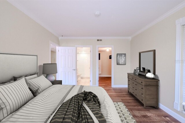 601 W Old Highway 441 Unit 11B, Mount Dora, FL 32757 - bedroom featuring crown molding, wood finished floors, baseboards, and connected bathroom