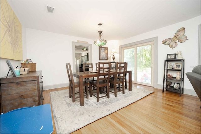 dining space with wood-type flooring