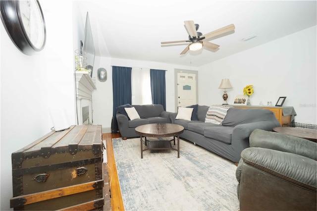 living room with hardwood / wood-style flooring and ceiling fan