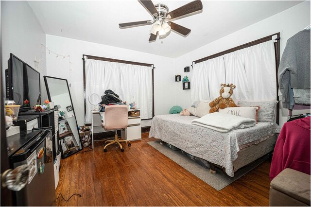 bedroom featuring ceiling fan and dark hardwood / wood-style floors