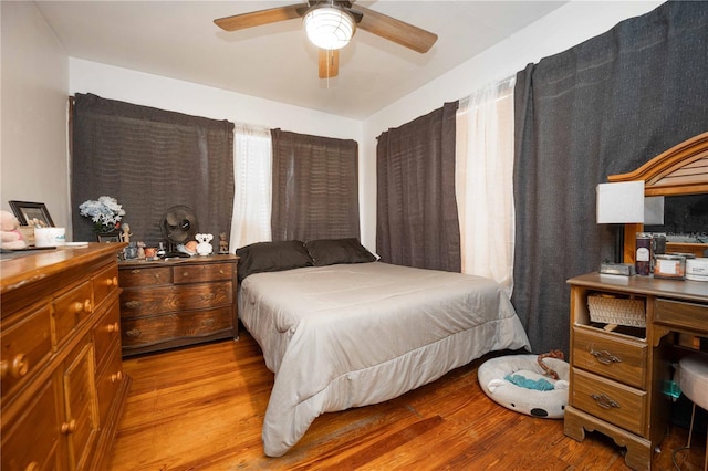 bedroom with ceiling fan and light hardwood / wood-style floors