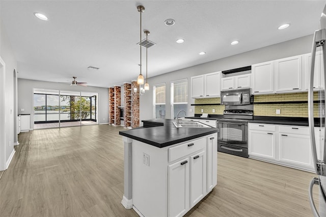 kitchen featuring ceiling fan with notable chandelier, black appliances, pendant lighting, light hardwood / wood-style flooring, and white cabinets