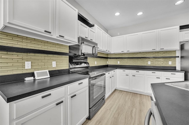 kitchen with black appliances, white cabinetry, light hardwood / wood-style flooring, and tasteful backsplash