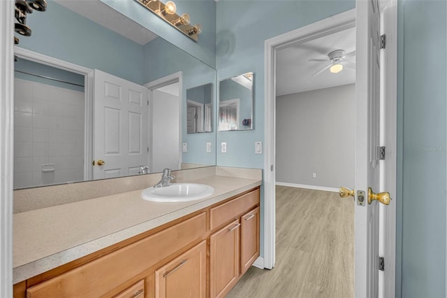 bathroom with ceiling fan, vanity, and wood-type flooring