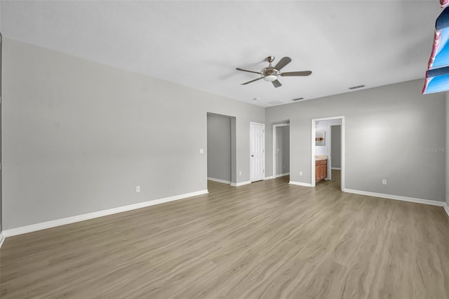 unfurnished bedroom with ensuite bath, ceiling fan, and light hardwood / wood-style floors