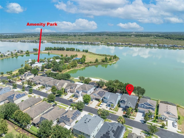 birds eye view of property with a water view