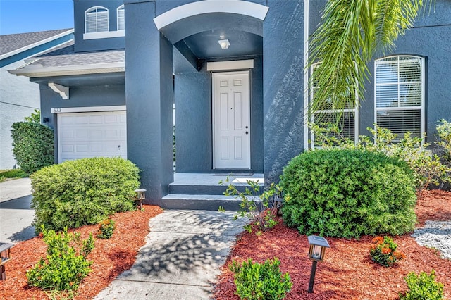 doorway to property with a garage