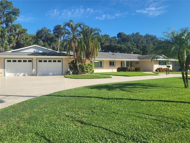 ranch-style home featuring a garage and a front lawn