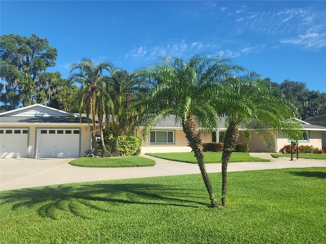 view of front of property featuring a garage and a front lawn