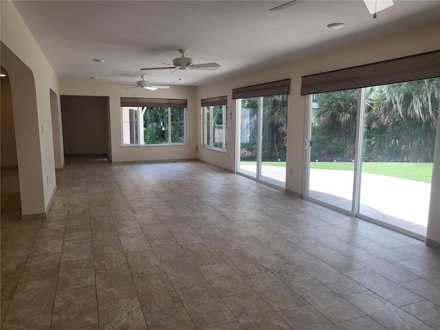 unfurnished room with ceiling fan