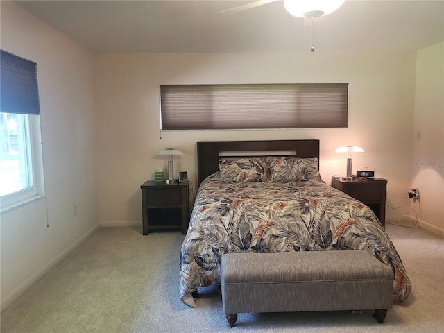 bedroom with light carpet and ceiling fan