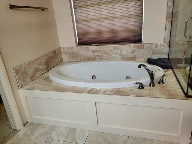 bathroom featuring a relaxing tiled tub