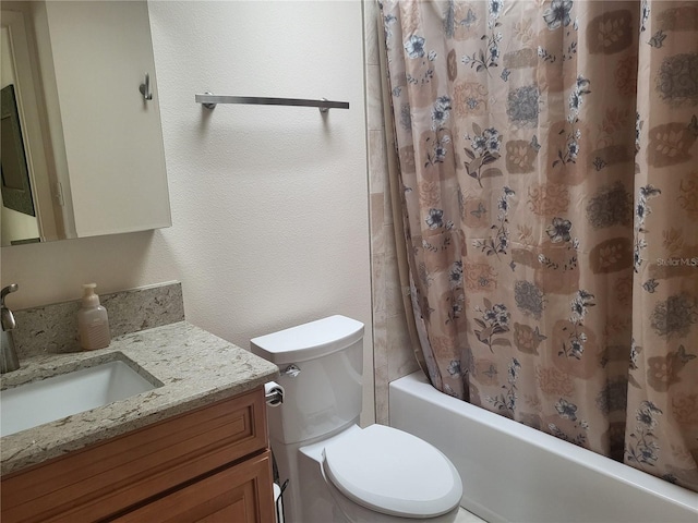 full bathroom featuring vanity, shower / bath combo, and toilet