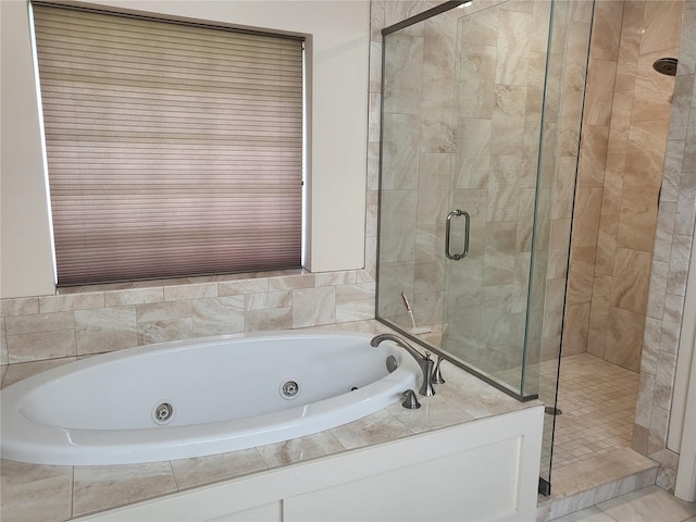 bathroom with shower with separate bathtub