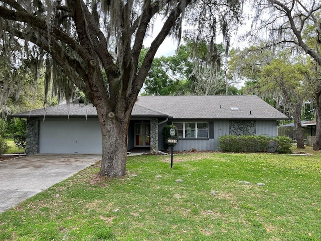 ranch-style home featuring a garage and a front lawn