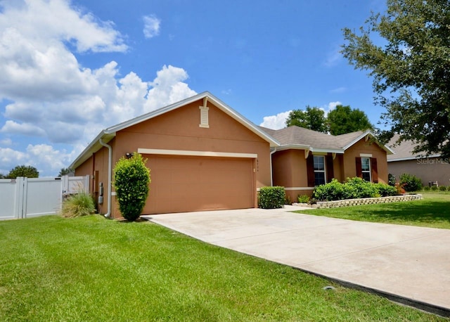 ranch-style home with a garage and a front yard