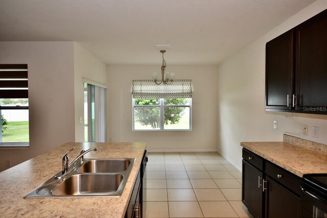 kitchen with light tile patterned flooring, sink, hanging light fixtures, a notable chandelier, and dark brown cabinets