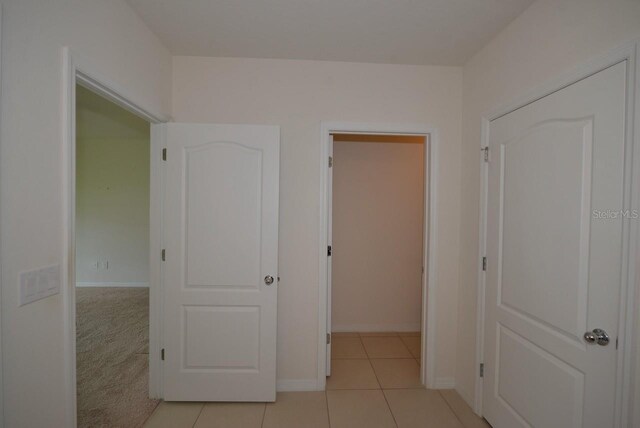 corridor with light tile patterned floors