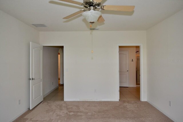 spare room with light carpet and ceiling fan