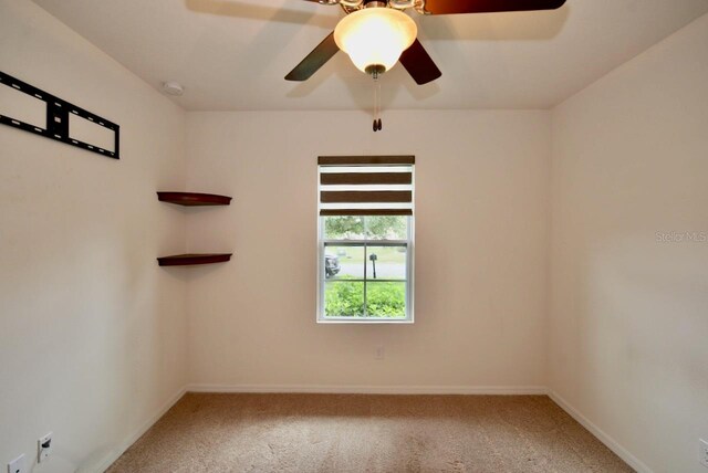 unfurnished room featuring ceiling fan and carpet flooring