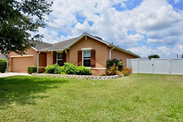 view of front of home with a garage and a front lawn