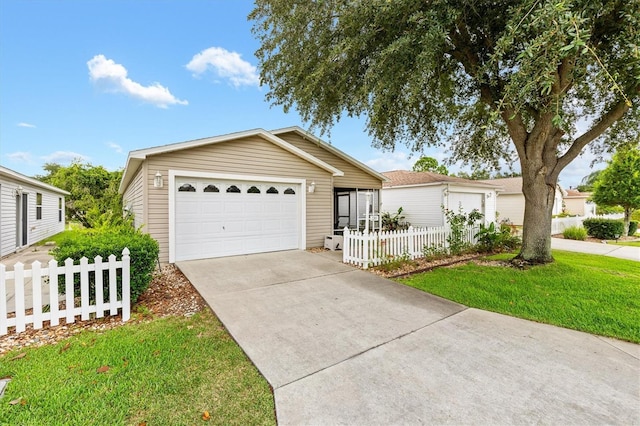 view of front facade with a front yard and a garage