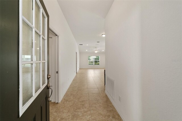 hallway with light tile patterned floors