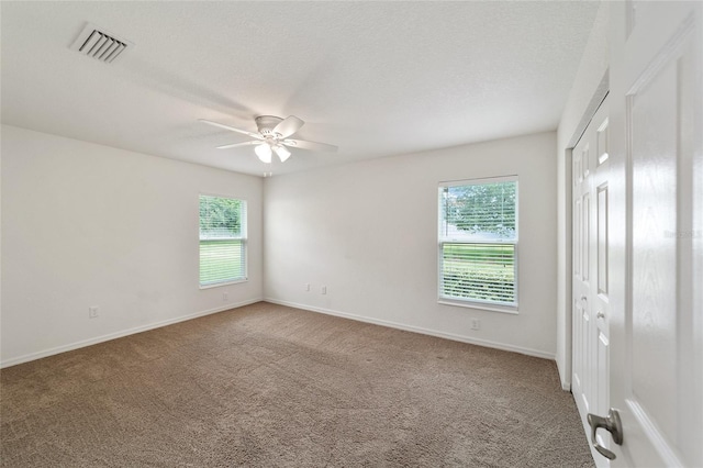 carpeted empty room featuring ceiling fan