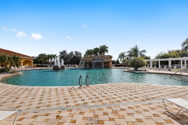 view of swimming pool with pool water feature