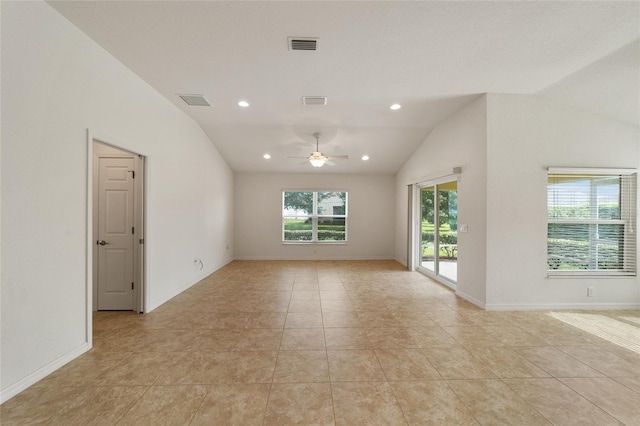 tiled spare room with plenty of natural light, ceiling fan, and lofted ceiling